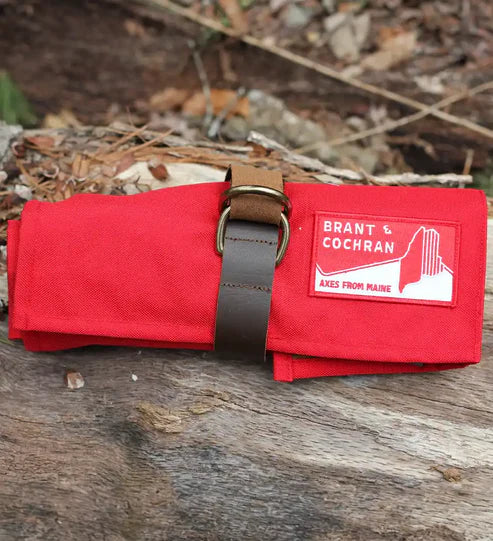 Closed red Brant and Cochran Axe Care Kit roll outdoors