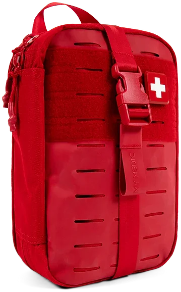 The red MyFAK first aid kit, closed, with its laser-cut MOLLE front panel and white cross patch