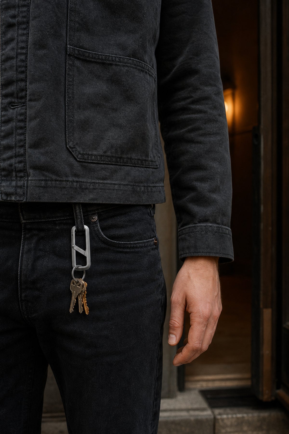 A relaxed hand beside The Madison clipped securely to a belt loop