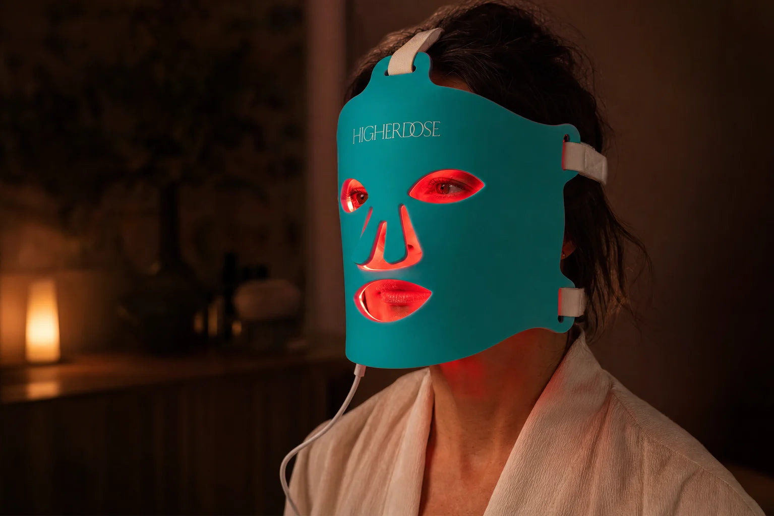 Woman in her forties during a private red light mask session at home