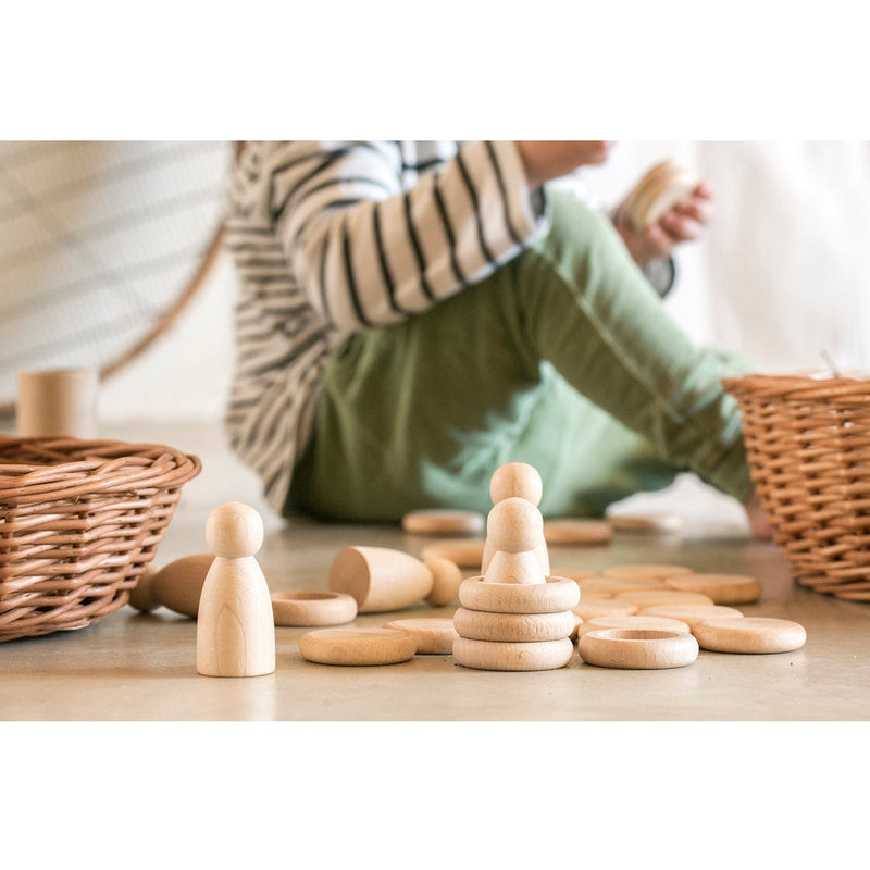 Grapat Nins figures with stacked rings and coins on the floor
