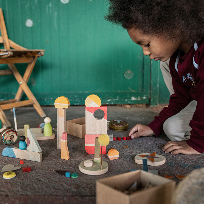 Child playing with Grapat Happy Place wooden houses and figures