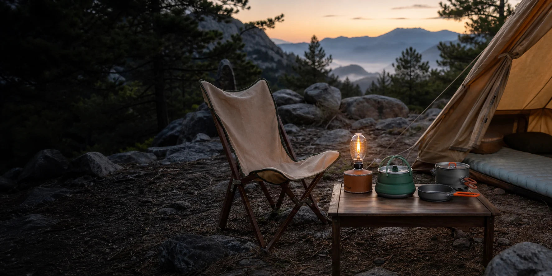 A canvas chair, lantern, kettle and camp cookware arranged at a high-desert campsite at dawn