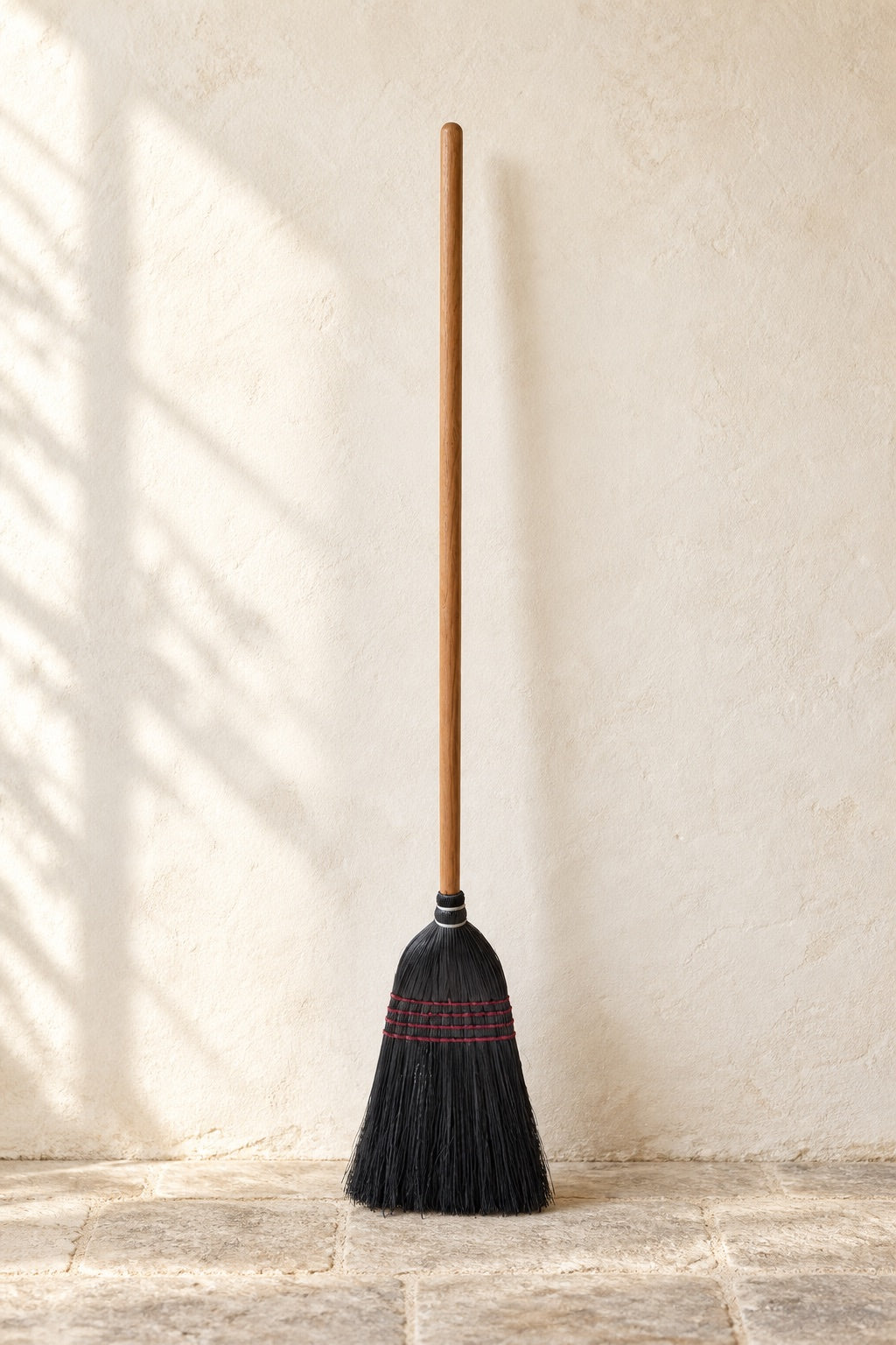 Full-length black Everyday Broom with its solid oak handle