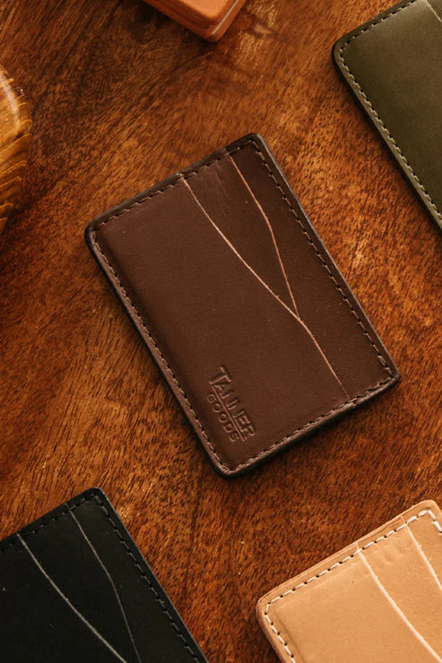 Journeyman cardholders in several leather colors arranged on dark wood