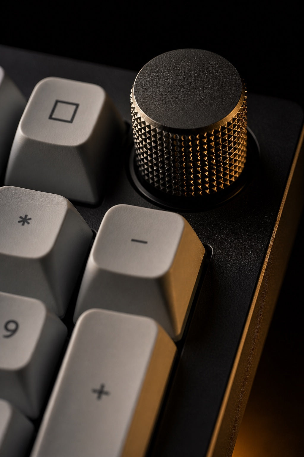 Macro of the Q5 Max's knurled machined aluminum control knob catching warm light.