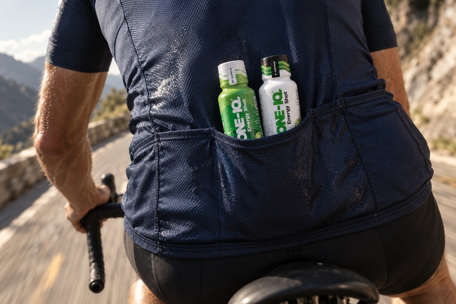 Two Ketone-IQ shots in the back pocket of a cyclist's jersey on a climb