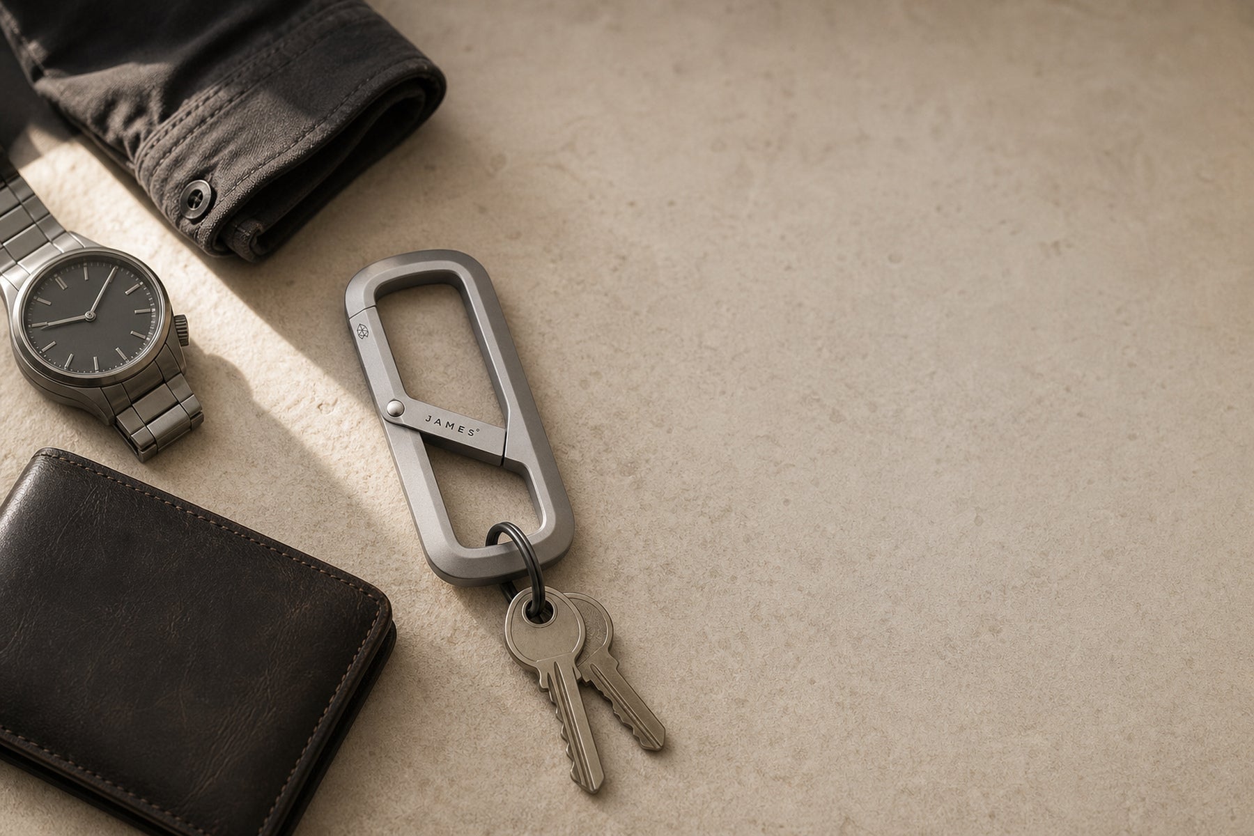 The Madison among a watch, wallet and jacket on a warm stone entry table
