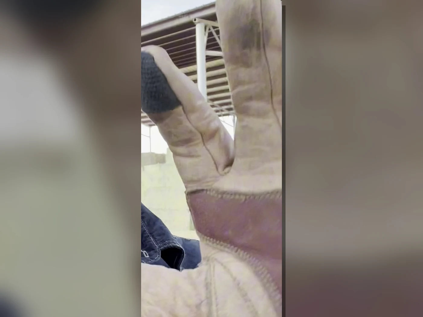 Actual broken-in buffalo leather glove with softened hide and working creases