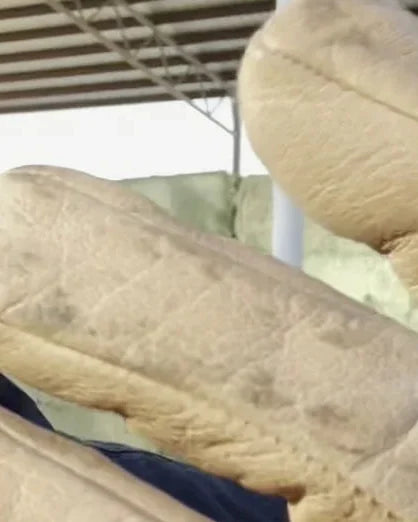 A worked glove with creased, softened fingers