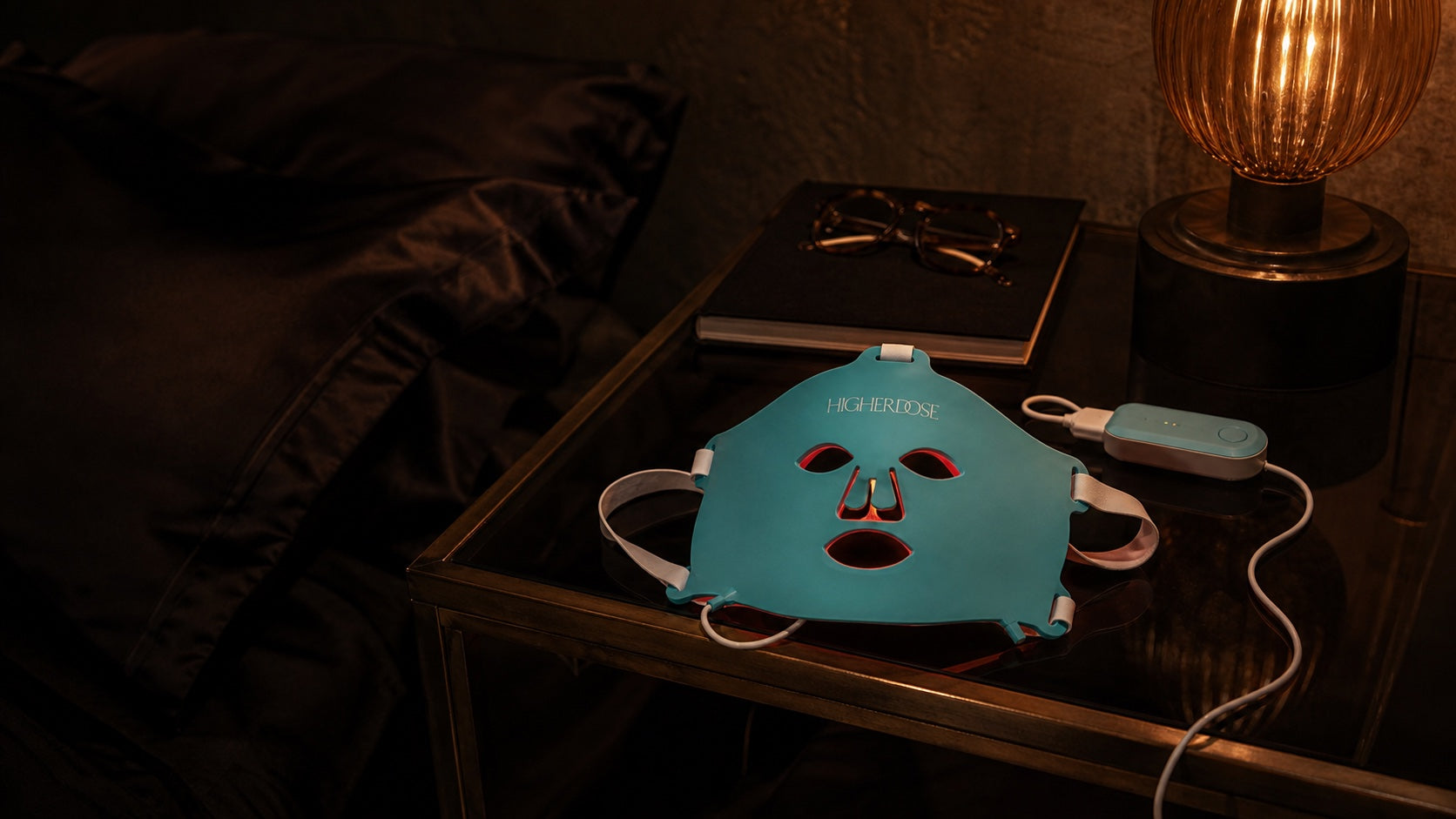 HigherDOSE mask resting on a bedside table, ready for an evening session