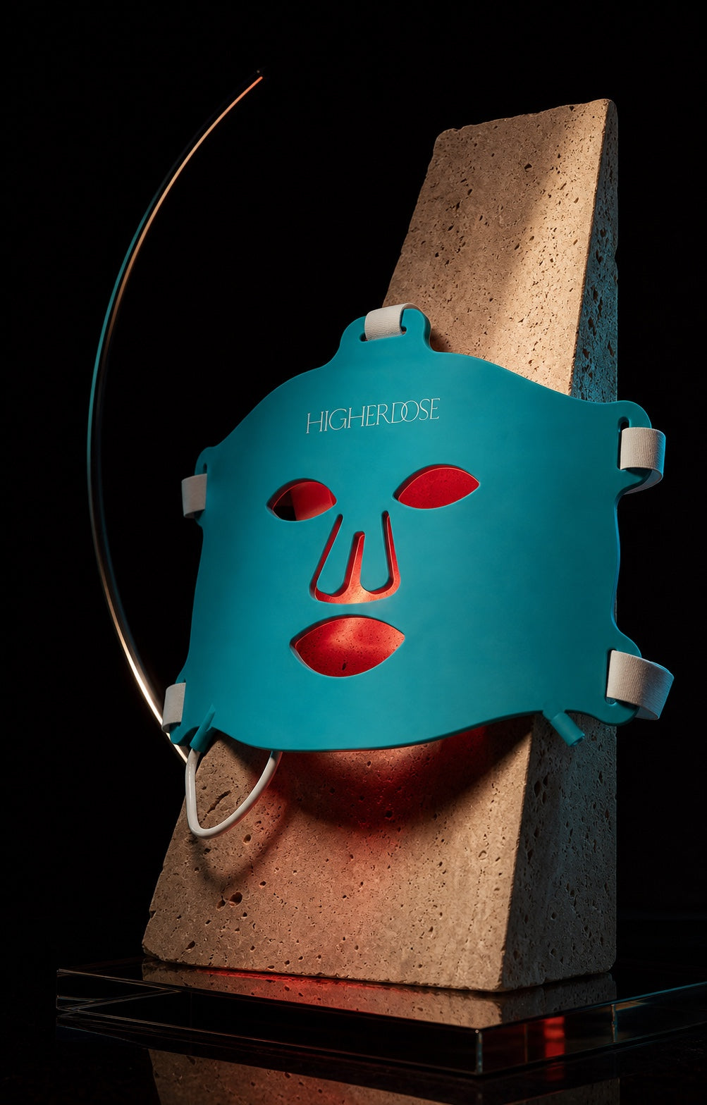 HigherDOSE mask presented as a sculptural design object over travertine