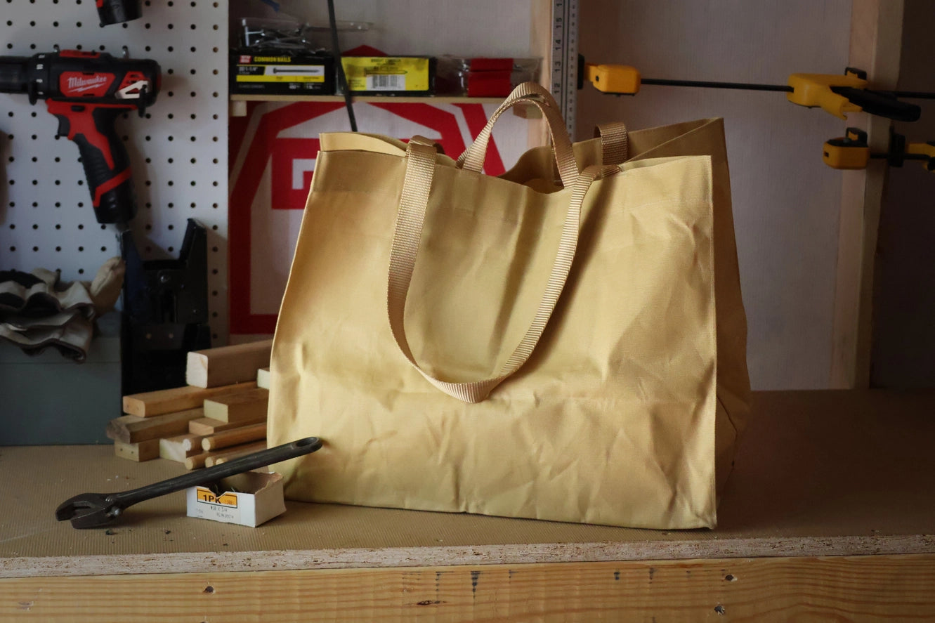 Sand and Gold tote in a hardware workshop