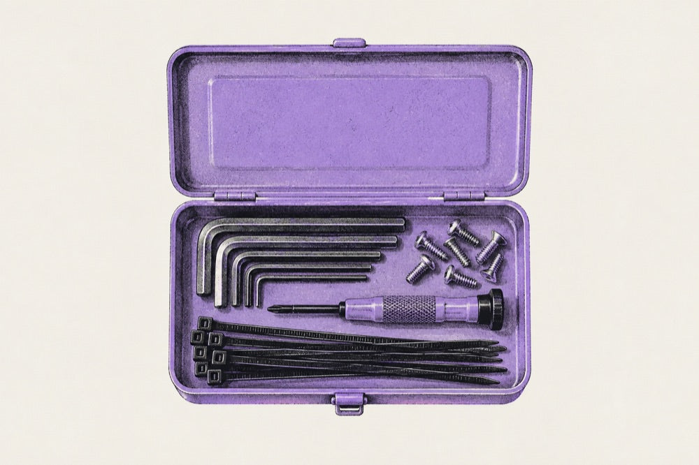 An open lilac T-152 with hex keys, a screwdriver and zip ties